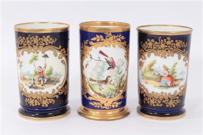 Lot 232 - Pair Early 19th century Chamberlain Worcester spill vases, painted in polychrome enamels with pastoral scenes, in gilt scrollwork cartouches, on a cobalt ground with gilt rims, stamped marks to bas...
