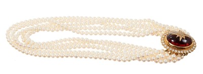 Lot 675 - Cultured pearl five-strand choker necklace with cabochon garnet and diamond cluster clasp