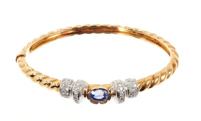 Lot 676 - 18ct gold tanzanite and diamond hinged bangle