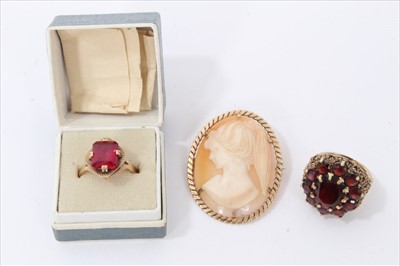 Lot 3248 - 9ct gold garnet cluster ring, 9ct gold and red stone ring and a gold mounted carved cameo brooch (3)