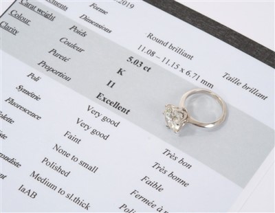 Lot 609 - Fine diamond single stone ring with a round brilliant cut diamond weighing 5.03 carats, accompanied by a Diamond Report by Gemmological Certification Services stating the colour grade K, clarity I1...