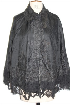 Lot 3098 - Victorian textiles to include three Victorian black capes,  pair of Victorian drawers and a fine cream printed silk cape etc.