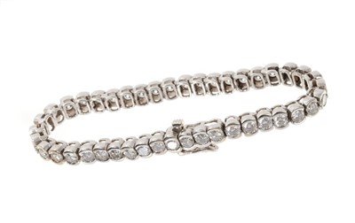 Lot 614 - Diamond tennis bracelet with a line of 43 brilliant cut diamonds estimated to weigh approximately 6.90 carats in total, in rub-over white gold setting. 17cm length.