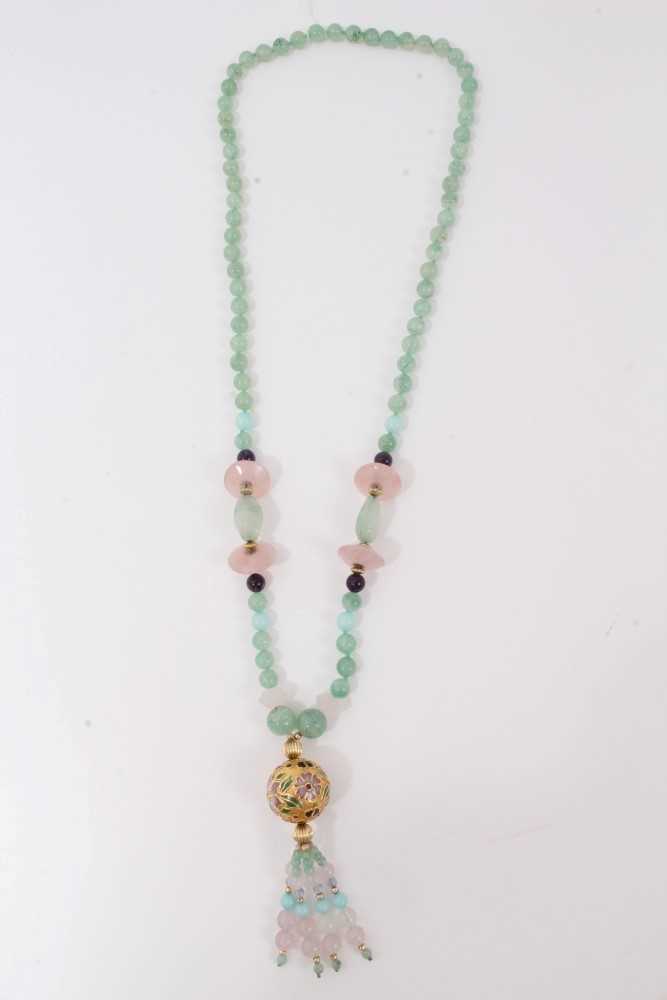 Lot 53 - Green hardstone bead necklace decorated with rose quartz beads and gilt floral enamelled large bead with beaded tassel finial