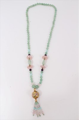 Lot 53 - Green hardstone bead necklace decorated with rose quartz beads and gilt floral enamelled large bead with beaded tassel finial