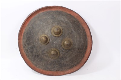 Lot 601 - 19th Century Indo Persian Dhal shield, of hide construction with brass fittings, 47 cm in diameter