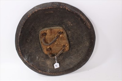 Lot 601 - 19th Century Indo Persian Dhal shield, of hide construction with brass fittings, 47 cm in diameter