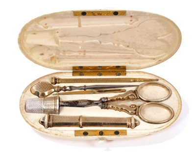 Lot 1239 - Good early 19th century French ivory cased etui, complete with gold and silver fittings within oval case with initialled plaque, 11cm long