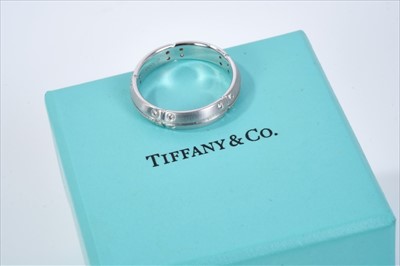 Lot 505 - Tiffany & Co. 18ct white gold and diamond wedding ring with brushed finish and brilliant cut diamonds. Stamped ‘Tiffany & Co. 2000, 750’ finger size R. Boxed