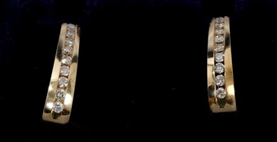 Lot 87 - Pair of  14ct gold and diamond hoop earrings, each with a line of channel set brilliant cut diamonds estimated to weigh approximately 1 carat in total. 21mm