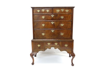 Lot 1621 - Early 18th century walnut crossbanded chest on stand, the upper section having two short over three graduated drawers, the later base with three drawers over shaped apron on cabriole legs, 99cm wid...