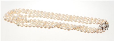 Lot 739 - Cultured Baroque pearl necklace with three strings of graduated pearls measuring 6.8 to 9.7mm on a white gold diamond, sapphire and pearl bow clasp.