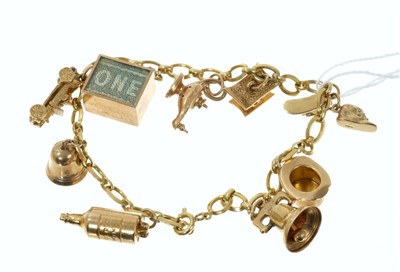 Lot 724 - 9ct gold charm bracelet with nine gold charms