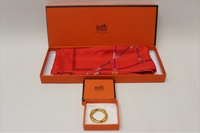 Lot 3121 - Hermes red silk scarf 1983 'Bolduc' designer Jean-Louis Dumas and Hermes gilt metal scarf ring, both boxed