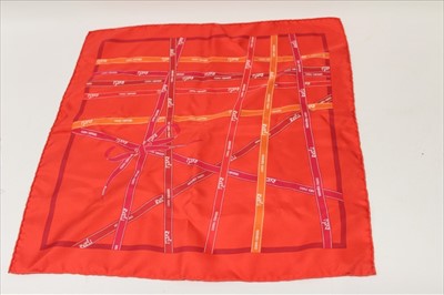Lot 3121 - Hermes red silk scarf 1983 'Bolduc' designer Jean-Louis Dumas and Hermes gilt metal scarf ring, both boxed