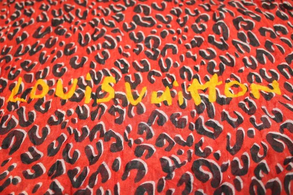 Lot 3122 - Louis Vuitton Red and Black 'Leopard' cashmere and silk scarf designed by Stephen Spouse in  box