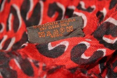 Lot 3122 - Louis Vuitton Red and Black 'Leopard' cashmere and silk scarf designed by Stephen Spouse in  box