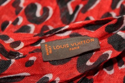 Lot 3122 - Louis Vuitton Red and Black 'Leopard' cashmere and silk scarf designed by Stephen Spouse in  box