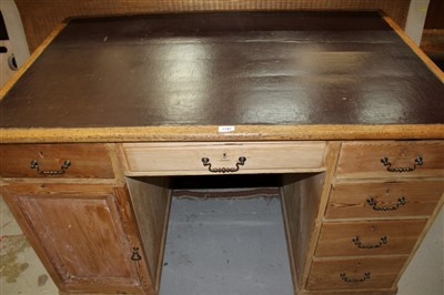 Lot 1747 - Early 20th century limed oak and pine desk, with leatherette inset top over six drawers sand one cupboard to the kneehole on plinth base