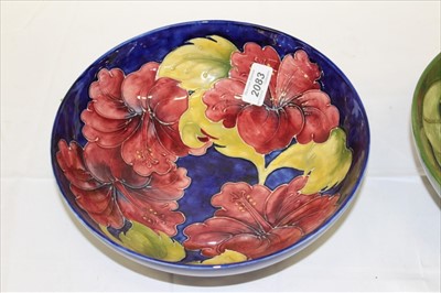 Lot 2083 - Moorcroft pottery bowl decorated in the Hibiscus pattern on blue ground and one other on green ground, both with impressed marks and painted signatures (2)