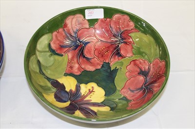Lot 2083 - Moorcroft pottery bowl decorated in the Hibiscus pattern on blue ground and one other on green ground, both with impressed marks and painted signatures (2)