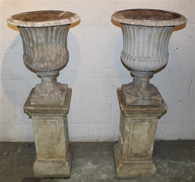 Lot 1755 - Pair of Classical style garden urns, each of fluted form, 60c, high raised on square plinth and base