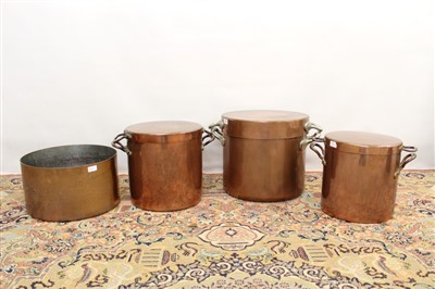 Lot 1757 - Three large graduated copper vessels and covers, each of plain cylindrical lidded form with two projecting handles, together with straight side beaten copper vessel. (4)