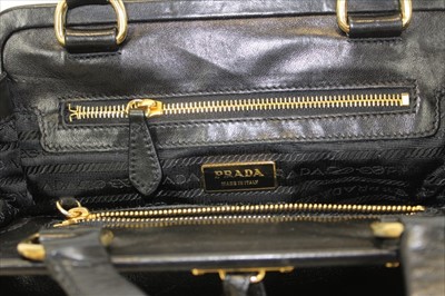 Lot 3084 - Prada Handbag in soft Nappa black leather.  Two handles and hanging tag. Zipped pockets. Black logo lining and soft dust bag. Authenticity card BR 1922,  January 2004.