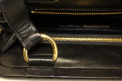 Lot 3084 - Prada Handbag in soft Nappa black leather.  Two handles and hanging tag. Zipped pockets. Black logo lining and soft dust bag. Authenticity card BR 1922,  January 2004.