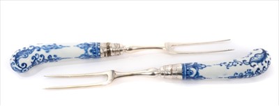 Lot 11 - Two 18th century Bow blue and white porcelain pistol-handled forks, with two-pronged steel tines, 21cm length