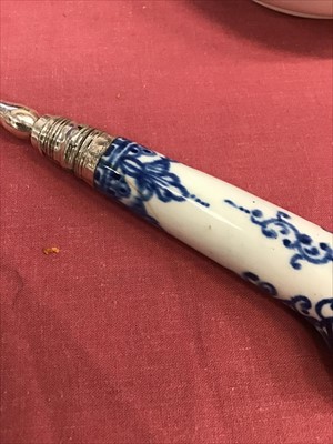 Lot 11 - Two 18th century Bow blue and white porcelain pistol-handled forks, with two-pronged steel tines, 21cm length