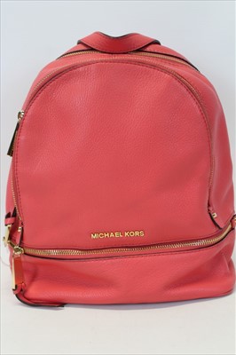 Lot 3112 - Michael Kors Pink leather back pack with engraved zipper pulls and circular logo lining.