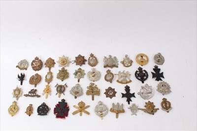 Lot 527 - Group of forty British military cap badges to include Machine Gun Corps, Cheshire Regiment and Royal Army Medical Corps