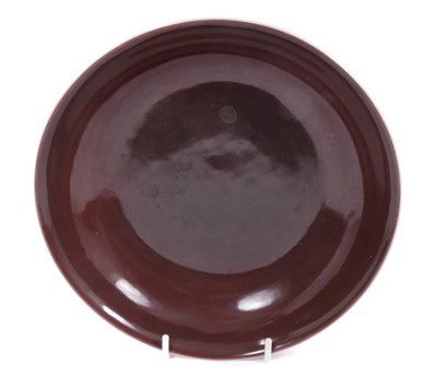 Lot 43 - Fine Chinese Qing dynasty aubergine glazed saucer dish, finely potted with rounded sides and flared rim, on a short foot, with Daoguang seal mark in underglaze blue