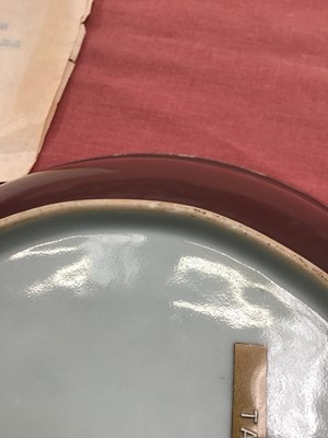Lot 43 - Fine Chinese Qing dynasty aubergine glazed saucer dish, finely potted with rounded sides and flared rim, on a short foot, with Daoguang seal mark in underglaze blue