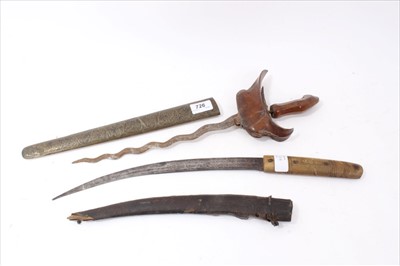 Lot 726 - 19th century Kris with watered waved blade in sheath and  an eastern dagger (2)