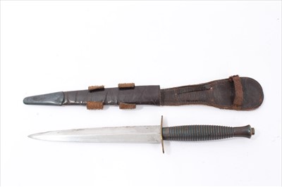 Lot 729 - Second World War British third pattern F.S. Commando knife with ribbed hilt with raised number 3, brass cross guard, in brass mounted leather sheath with integral frog and elasticated retaining str...