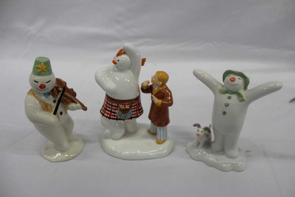Lot 2129 - Three Coalport characters- The Snowman figures, (in original boxes), together with a Beswick and a Royal Doulton Snowman figure (5)