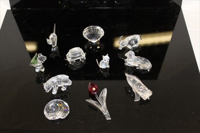 Lot 2159 - Collection of Swarovski Crystal ornaments, to include a buffalo, teddy bear, oyster shell, speedboat, snail shell, cat, sheep, polar bear, tulip, wagon, and ducks all boxed (11)