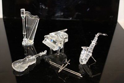 Lot 2161 - Swarovski Crystal musical instrument ornaments, to include Grand Piano, saxophone, violin and harp (4)