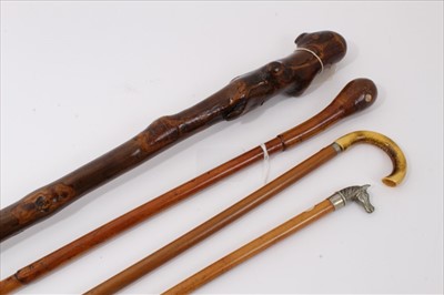 Lot 3691 - Early 20th century "Natural" walking stick, possibly Holly, 92cm, together with an cane swagger stick with white metal horse's head handle 67cm another with hollow crook handle 69cm and one other s...