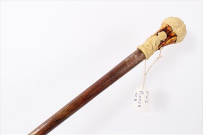 Lot 3682 - Early 20th century Hickory walking stick with moulded earthenware in the form of a classical child sitting under a tree and drilled for a sash cord, 81.5cm overall length