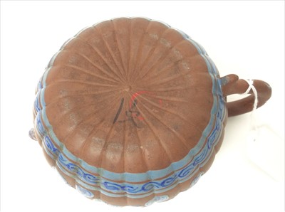 Lot 3736 - Three Chinese items 19th to 20th century, including Yixing teapot with blue enamel decoration and white enamel character marks, a carved wooden temple figure reputedly wahed up on the shore of a ri...
