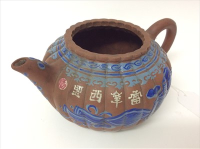 Lot 3736 - Three Chinese items 19th to 20th century, including Yixing teapot with blue enamel decoration and white enamel character marks, a carved wooden temple figure reputedly wahed up on the shore of a ri...