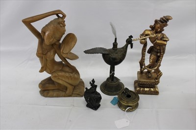 Lot 3737 - Indian brass inkwell in the form of a bird, and further Indian ornaments, to include another inkwell, a lidded bottle, a gilt figure, and a carved wooden figure (5)