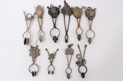 Lot 3739 - Collection of 10 antique Victorian and later ladies' skirt lifters, including ones with floral decoration, geometric patterns, etc (10)