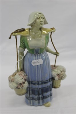 Lot 2169 - Unusual Royal Doulton Lambeth pottery figure of a woman carrying two baskets of flowers, with impressed marks to base, 23.5cm height