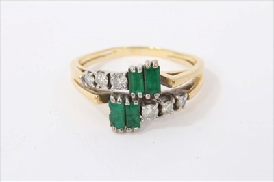 Lot 241 - 18ct gold emerald and diamond cross-over ring with four step cut emeralds and graduated brilliant cut diamonds in claw setting on gold shank