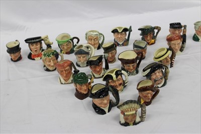 Lot 2177 - Twenty-three Royal Doulton character jugs including The Caroler D7007, Old Charley, Bacchus D6521 and The Lawyer D6524