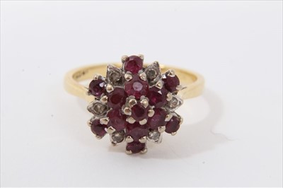 Lot 3438 - 18ct gold ruby and diamond cluster ring with a flower head cluster in tiered claw setting on 18ct gold shank